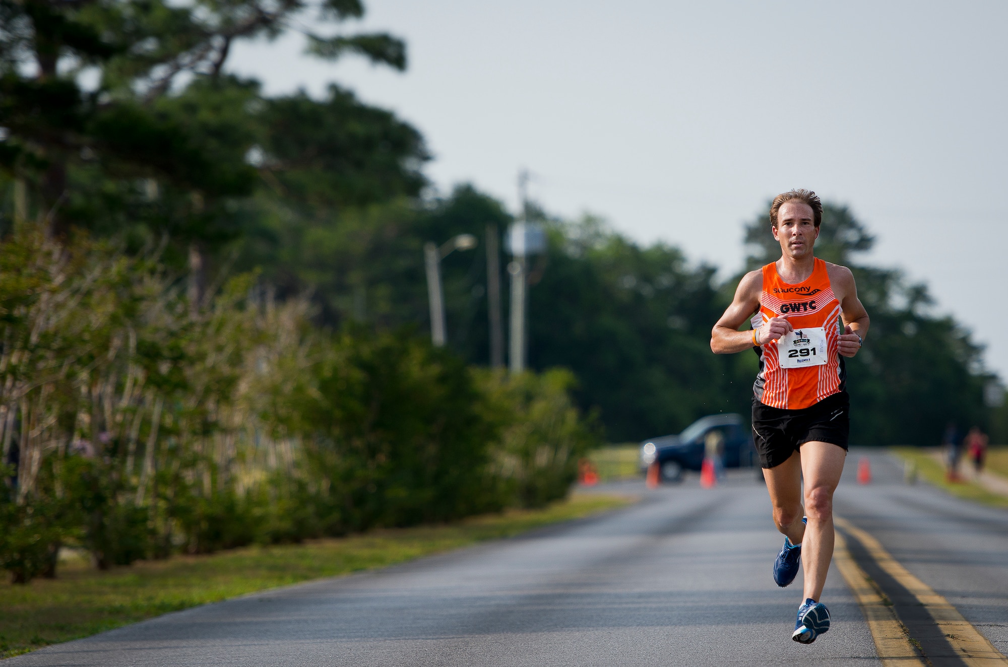 Vince Molosky strides toward the finish line more than 40 seconds ahead of everyone else at the 29th annual Gate-to-Gate Run May 24 at Eglin Air Force Base, Fla.   Molosky finished in 24 minutes 39 seconds taking first place.  More than 1,200 people participated in the 4.4-mile race. Many of the runners paid their respects by dropping off flowers in front of the All Veterans Memorial as they raced by. (U.S. Air Force photo/Samuel King Jr.)