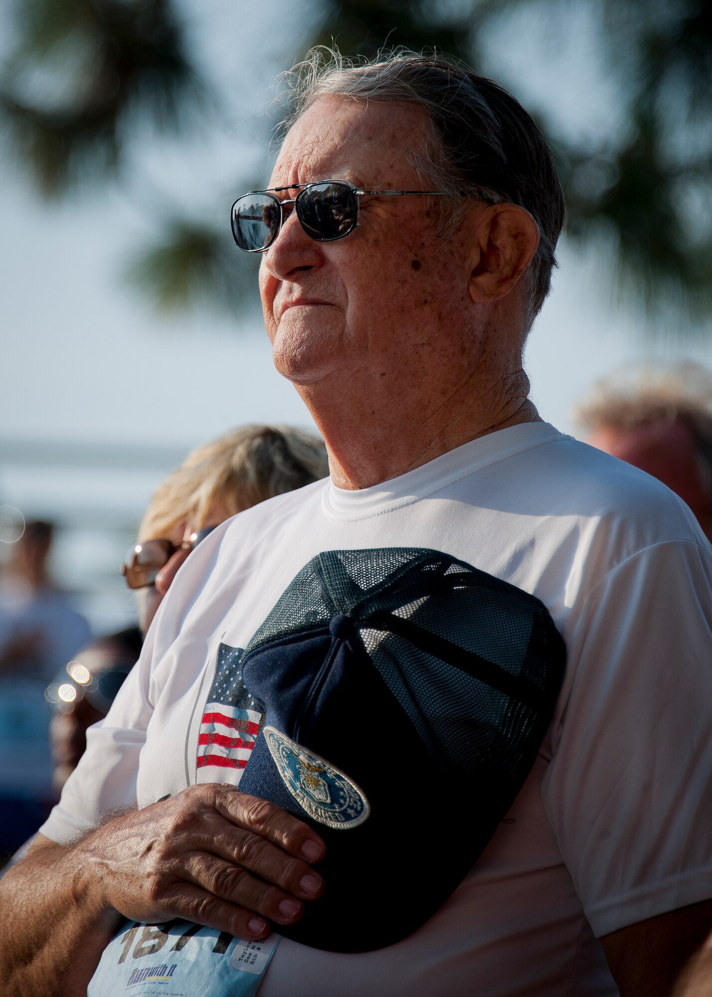 James Taylor covers his heart during the National Anthem at the 29th annual Gate-to-Gate Run May 24 at Eglin Air Force Base, Fla. More than 1,200 people participated in the 4.4-mile race. Many of the runners paid their respects by dropping off flowers in front of the All Veterans Memorial as they raced by. (U.S. Air Force photo/Samuel King Jr.)