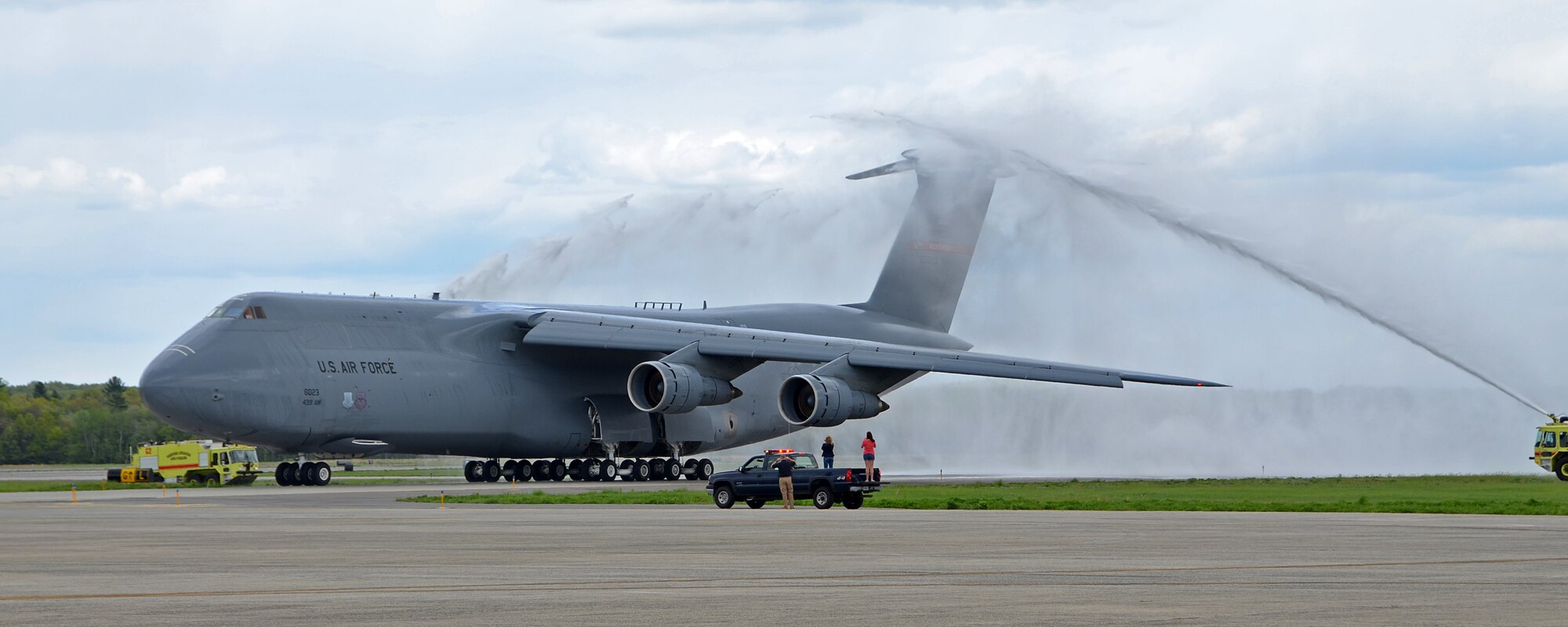 Col. Jeffrey Hancock's C-5 gets "hosed" by the Fire Department after his fini flight and landing at Westover, May 19, 2014. (US Air Force photo/MSgt. Andrew Biscoe)