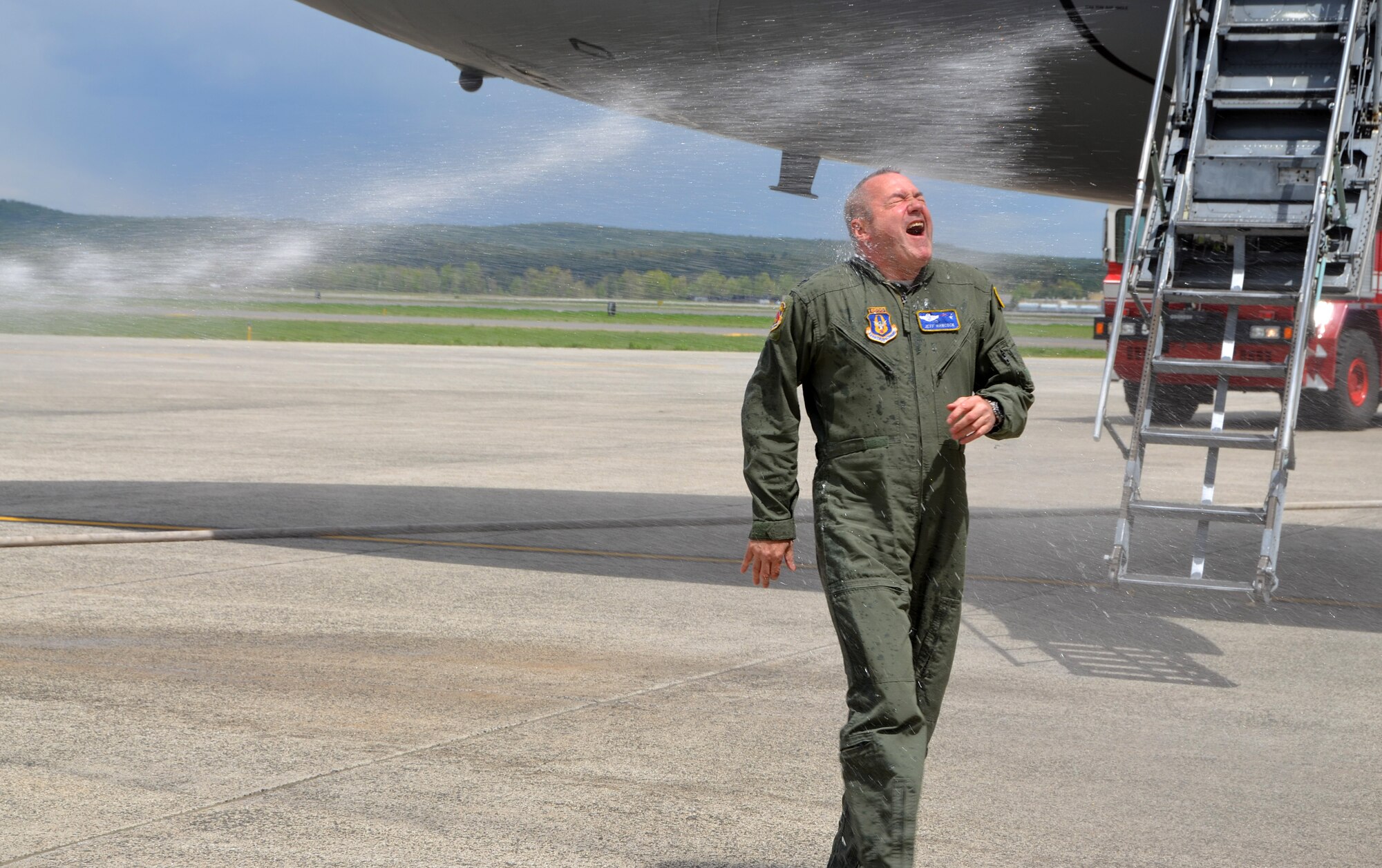 Col. Jeffrey Hancock gets "hosed" by his wife, Debbie, after his fini flight and landing at Westover, May 19, 2014. (US Air Force photo/MSgt. Andrew Biscoe)
