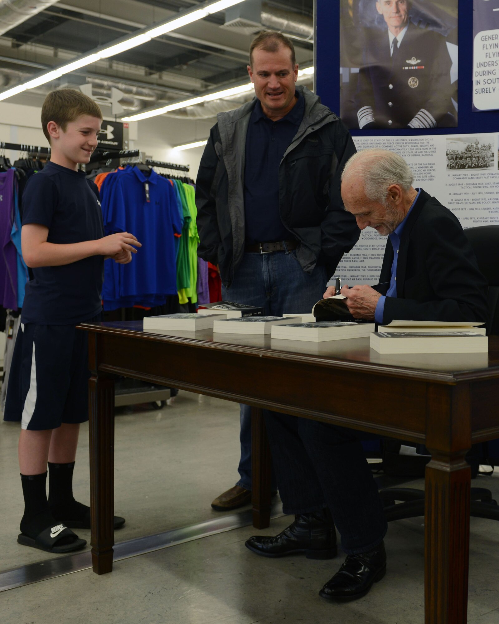 U.S. Air Force Col. Kenneth T. Bibb, 100th Air Refueling Wing commander, and his son, Ryan, speak with retired U.S. Air Force Gen. Merrill A. McPeak, the 14th chief of staff of the Air Force, during a visit May 24, 2014, to RAF Mildenhall, England. McPeak retired in 1994 after serving 37 years in the Air Force. (U.S. Air Force photo by Airman 1st Class Preston Webb/Released)