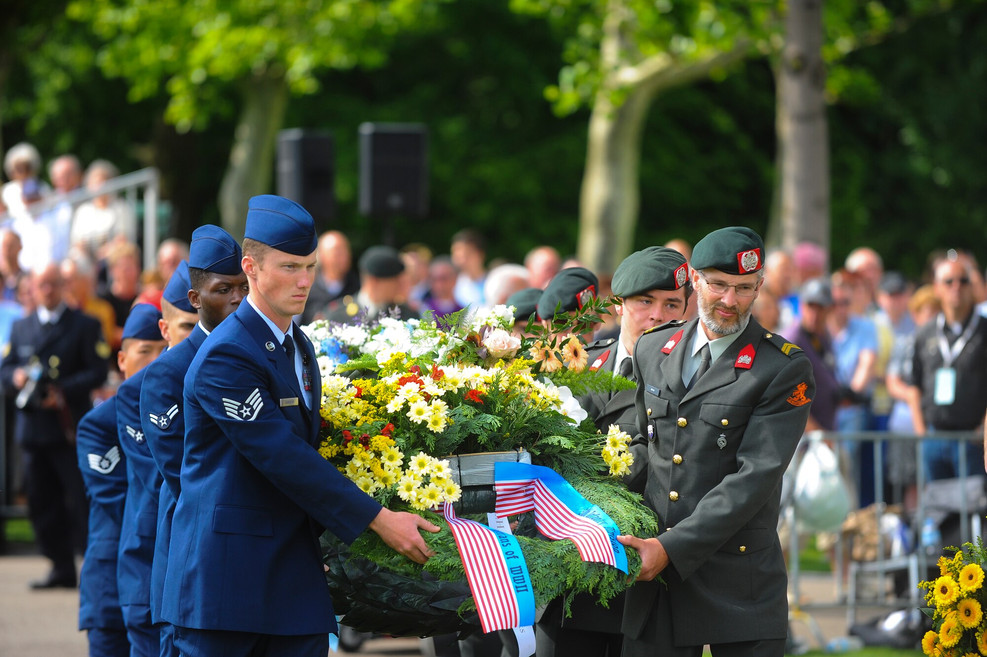 U.S. Air Force Airmen and Dutch service members lay wreaths during a Memorial Day ceremony at the Netherlands American Cemetery May 25, 2014, Margraten, Netherlands. During the ceremony, service members laid more than 60 wreaths to honor the memory of fallen heroes. (U.S. Air Force photo by Senior Airman Rusty Frank/Released)