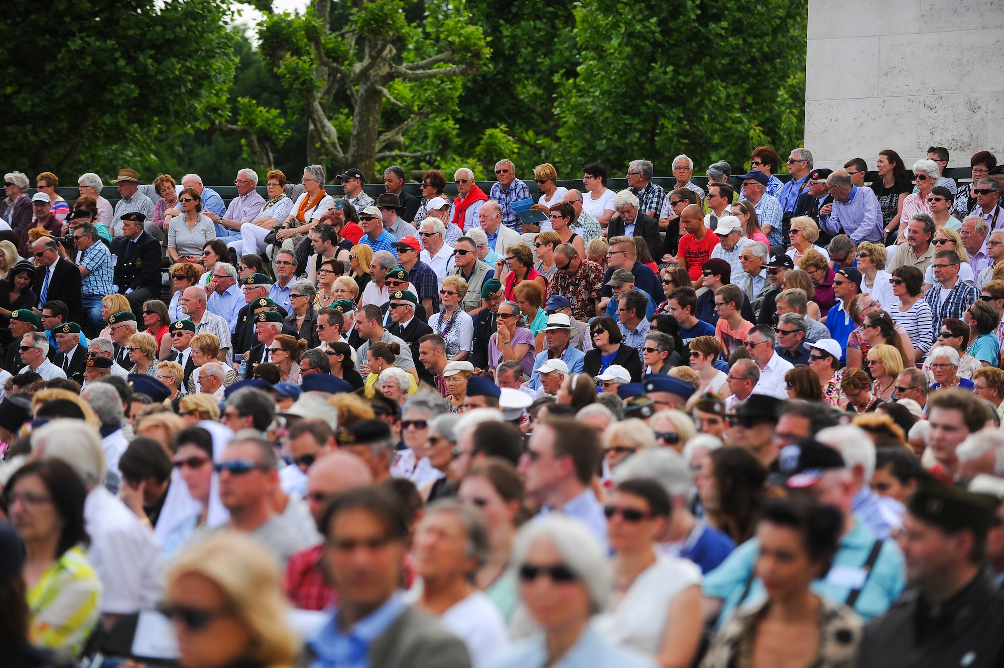 People gather to watch a Memorial Day ceremony at the Netherlands American Cemetery May 25, 2014, Margraten, Netherlands. The event is one of the largest ceremonies held at an overseas American Battle Monument Commission cemetery. (U.S. Air Force photo by Senior Airman Rusty Frank/Released)