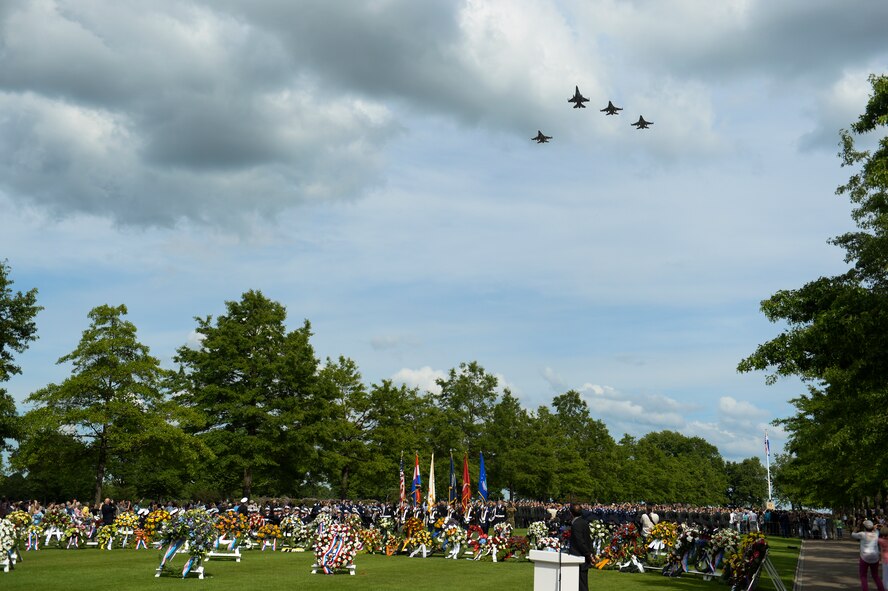 Dutch military aircraft perform a fly over at the end of a Memorial Day ceremony at the Netherlands American Cemetery May 25, 2014, Margraten, Netherlands. During the fly over, the pilots performed a missing-man formation. (U.S. Air Force photo by Senior Airman Rusty Frank/Released)