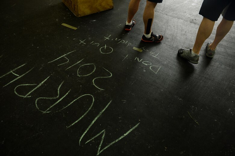 Spangdahlem Airmen wait to start a combat fitness workout during a "Murph" Challenge May 23, 2014, at Spangdahlem Air Base, Germany. The "Murph" Challenge is an annual event held to honor the memory of Medal of Honor recipient U.S. Navy Lt. Michael Murphy who died in Afghanistan in June 2005. (U.S. Air Force photo by Senior Airman Rusty Frank/Released)