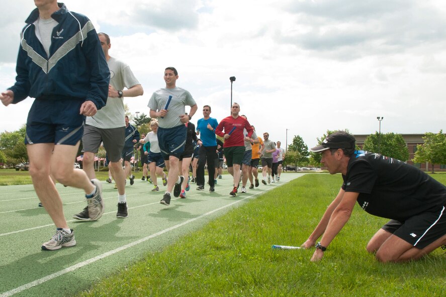 HANSCOM AIR FORCE BASE, Mass. - Lt. Col. Antonio Eppolito, Air Force Telehealth and Telemedicine chief, looks on as Airmen run past him during an “Efficient Running: The Art and Science of Becoming a Healthier and Better Runner workshop,” May 16. The two hour hands-on workshop focused on aerobic development, running form made simple to prevent injury as well as drills, strength and mobility for better performance. (U.S. Air Force photo by Mark Herlihy)