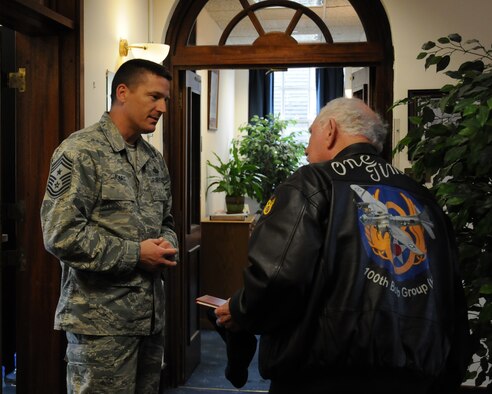 U.S. Air Force Chief Master Sgt. Tracy Jones, 100th Air Refueling Wing command chief, greets Joe Urice, a World War II veteran, during a base visit May 22, 2014, on RAF Mildenhall, England. Urice served from December 1944 to November 1945 with the 100th Bombardment Group as a B-17 Flying Fortress tail-gunner. (U.S. Air Force photo by Gina Randall/Released)