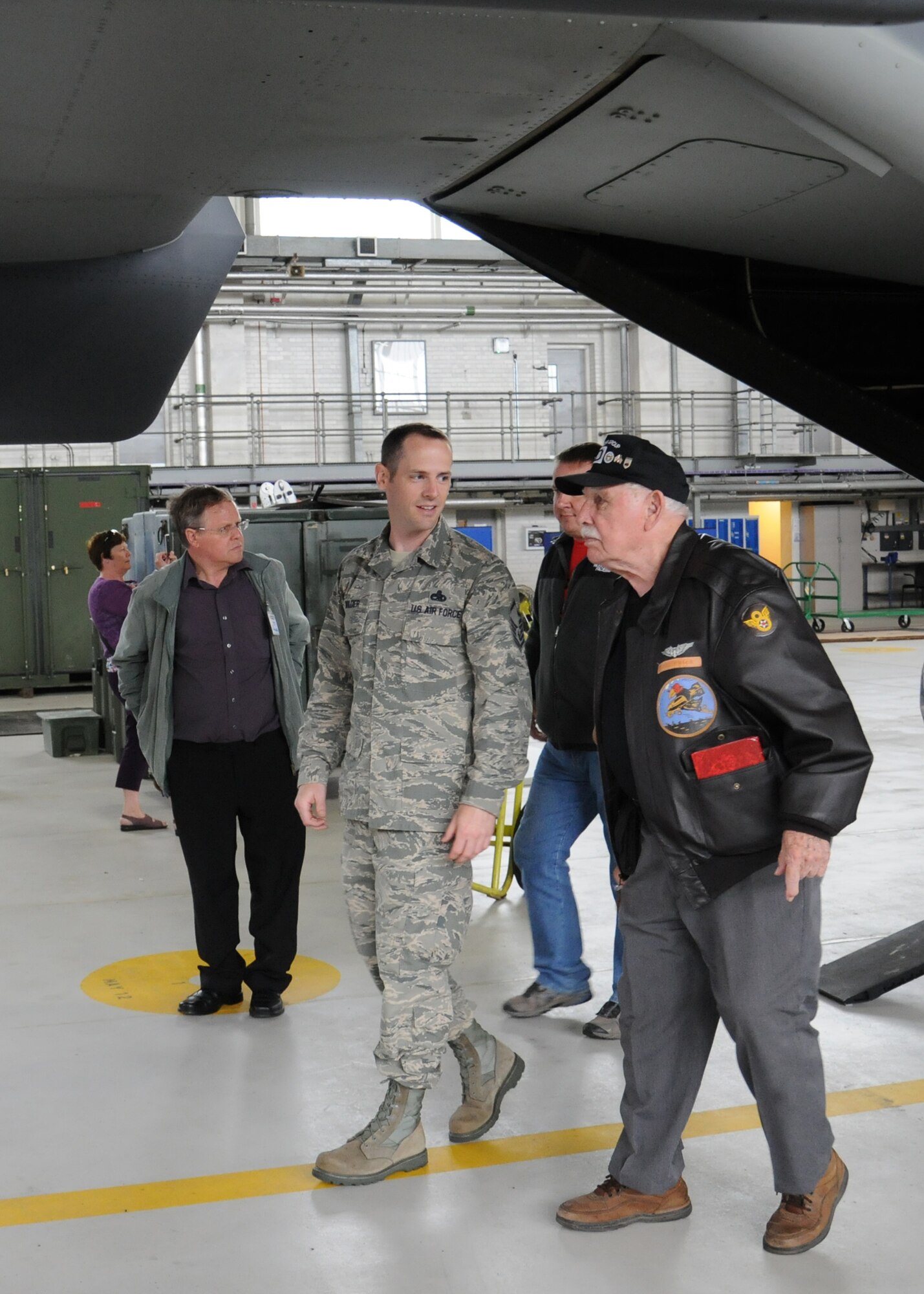 U.S. Air Force Master Sgt. Andrew Wilder, center, 100th Maintenance Group unit deployment manager from Hernando, Miss., speaks with Joe Urice, a World War II veteran, during a base visit May 22, 2014, on RAF Mildenhall, England. Urice served from December 1944 to November 1945 with the 100th Bombardment Group as a B-17 Flying Fortress tail-gunner. He visited the U.K. with his family and members of the 100th Bomb Group Foundation. (U.S. Air Force photo by Gina Randall/Released)