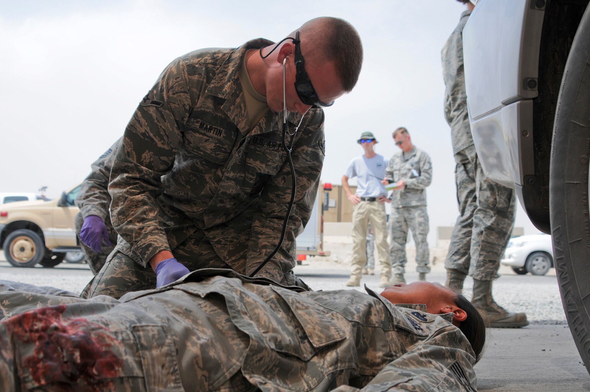 Airman Devin Martin, 386th Expeditionary Civil Engineering Squadron fire department, assess Staff Sgt. Delina Nugent after a mock active shooter scenario May 23, 2014 at an undisclosed location in Southwest Asia. Members of the 386th Air Expeditionary Wing participated in a base exercise that included multiple scenarios to challenge and train Airmen on potential threats in a deployed environment. (U. S. Air Force photo by 1st Lt. Holli Nelson)
