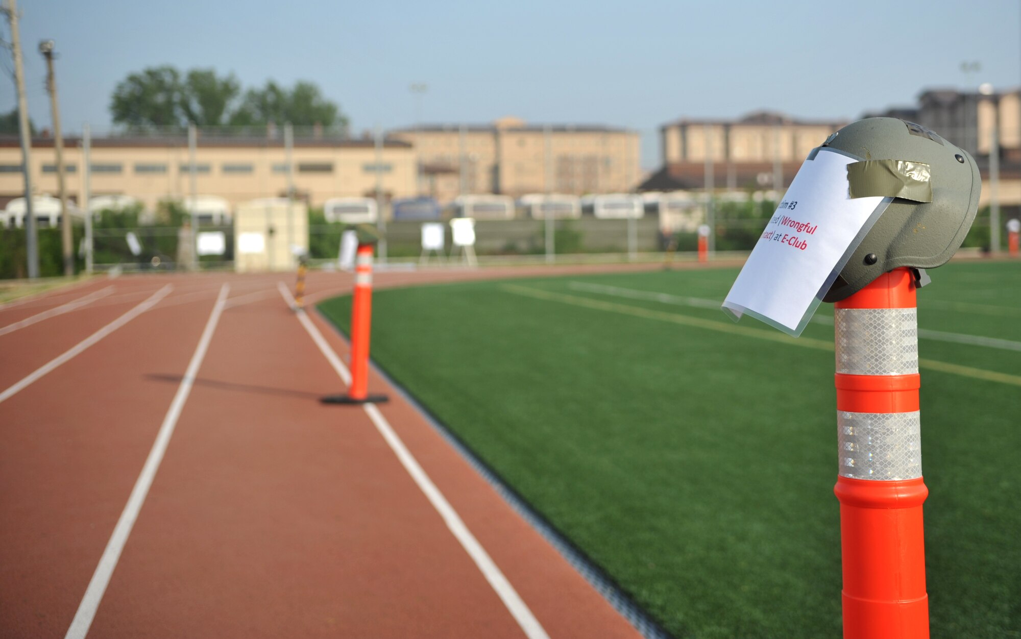 Helmets represent the base’s reported sexual assault cases during Fiscal Year 2013 at Osan Air Base, Republic of Korea, May 22, 2014. Airmen completed silent walks around the track as a tribute to the victims as part of a Sexual Assault Prevention and Response Down Day. (U.S. Air Force photo/Airman 1st Class Ashley J. Thum)