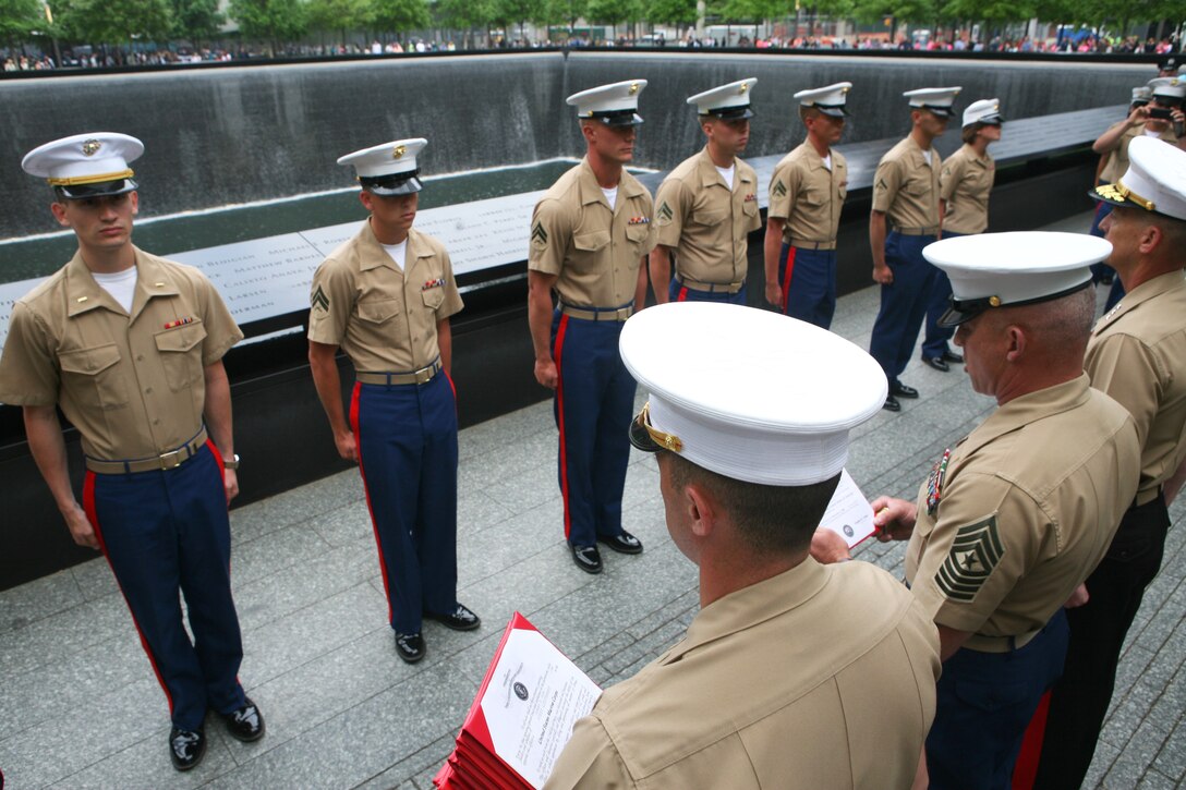 Marines stand at attention during a promotion ceremony at the 9/11 Memorial site during Fleet Week in New York, May 23, 2014.
