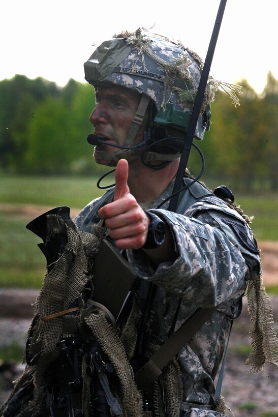 U.S. Army Capt. Nicholas Salimbene checks for status reports from his soldiers after a simulated airfield seizure with Lithuanian soldiers during exercise Black Arrow over Rukla training area in Lithuania, May 17, 2014. Salimbene commands Company L, 1st Battalion, 503rd Infantry Regiment, 173rd Airborne Brigade Combat Team.
