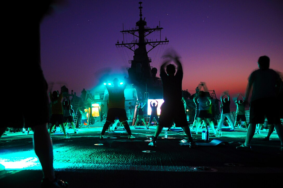 U.S. sailors exercise on the flight deck of the USS Benfold at night in the Arabian Sea, Oct. 10, 2012. The Benfold is deployed to the U.S. 5th Fleet area of responsibility, conducting maritime security operations, theater security cooperation efforts.  
