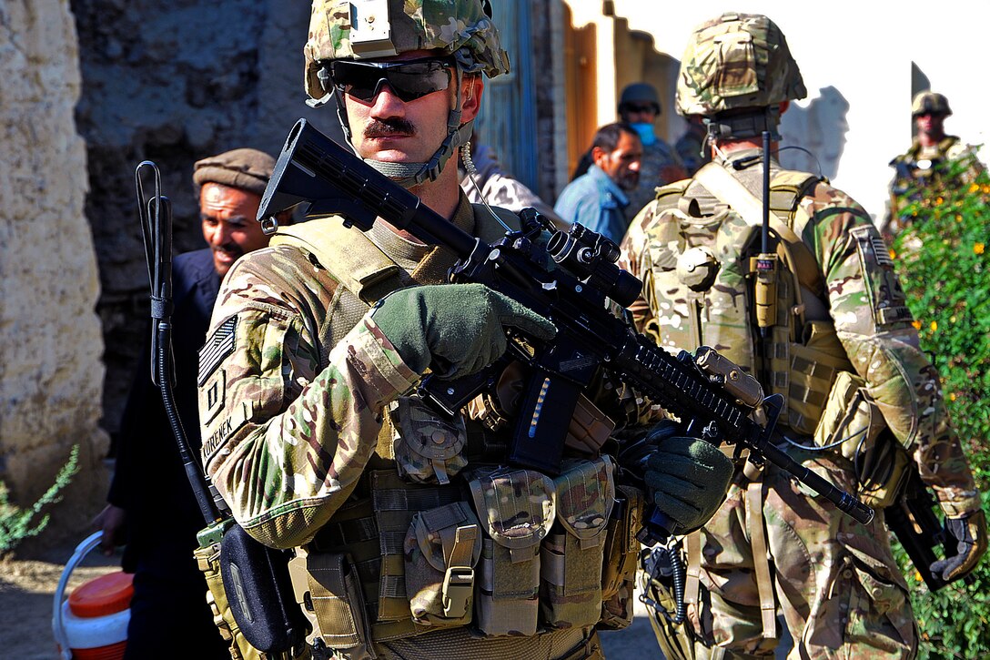 U.S. Navy Lt. Collin Korenek, front, provides security during a key leader engagement with district leaders in the Noorgul district center in Afghanistan's Kunar province, Oct. 1, 2012. Korenek is assigned to Provincial Reconstruction Team Kunar.  
