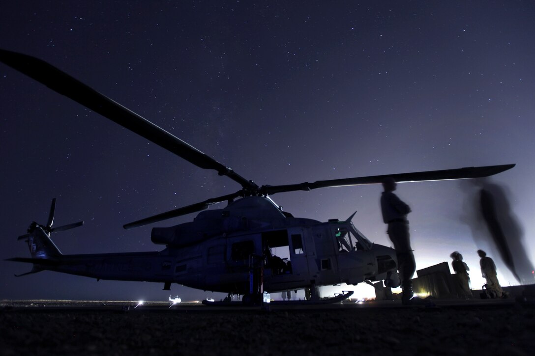 U.S. Marines wait for a flight next to an UH-1Y Venom helicopter on Camp Dwyer in Afghanistan's Helmand province, Oct. 4, 2012. The Marines, assigned to Marine Light Attack Helicopter Squadron 469, 3rd Marine Aircraft Wing, provided aviation support for counterinsurgency operations in southern Helmand.  
