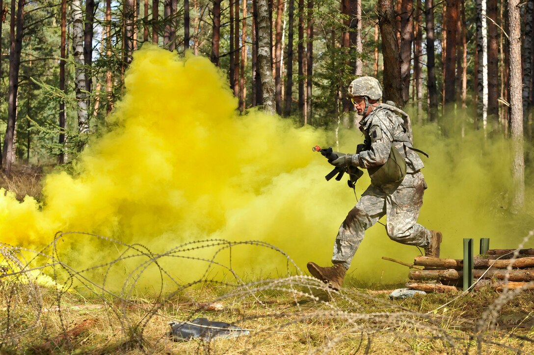 U.S. Army Capt. Christopher Harris moves through an obstacle during an U.S. Army Europe Expert Field Medical Badge examination in Grafenwoehr, Germany, Sept. 20, 2012. The exam provides multinational and U.S. service members with common standards and objectives for treating the sick and wounded, and improves communication among the frontline medical professionals fighting together.  
