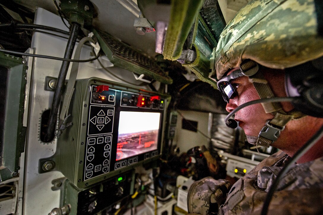 U.S. Army Spc. Warren Feeley looks through a fire control system inside an M1126 infantry carrier vehicle while engaging targets with a .50-caliber remote weapons system during a live-fire training exercise on Pohakuloa Training Area, Hawaii, Sept. 19, 2012. Feeley is assigned to the 25th Infantry Division's Company A, 1st Battalion, 21st Infantry Regiment, 2nd Stryker Brigade Combat Team.  

