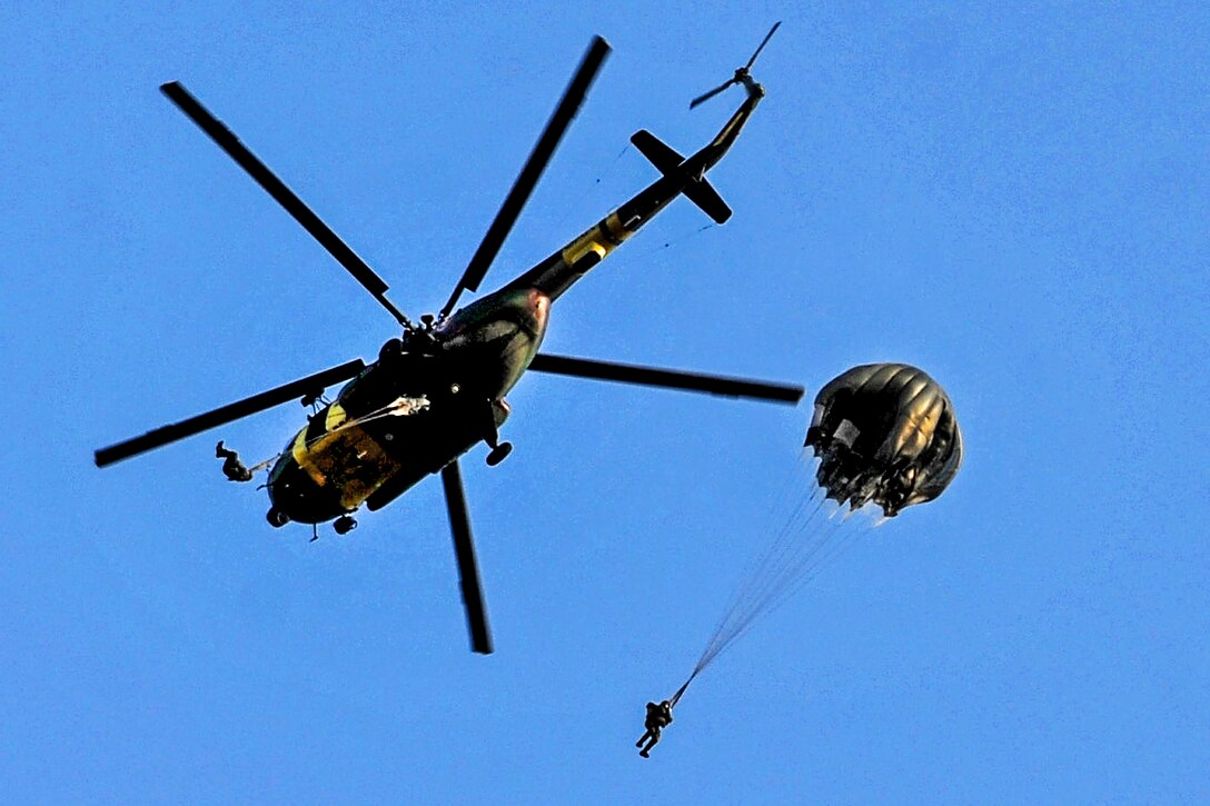 U.S. and Romanian soldiers perform a parachute jump from a Slovakian helicopter during exercise Jackal Stone 2012 in Udbina, Croatia, Sept. 17, 2012.  
