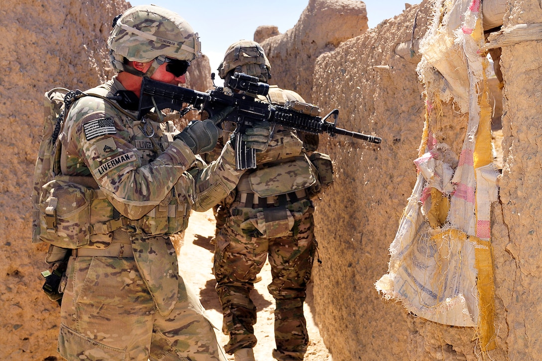 U.S. Army Cpl. Bobby Liverman, left, clears an area during Operation Southern Strike III in Jandad Kalay village in the Spin Boldak district of Afghanistan's Kandahar province, Sept. 9, 2012. Liverman, an infantryman, is assigned to the 2nd Infantry Division's Headquarters Company, 5th Battalion, 20th Infantry Regiment, 3rd Stryker Brigade Combat Team.  
