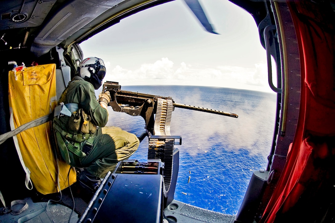 U.S. Navy Petty Officer 3rd Class Bobby Heimovitz fires a .50-caliber machine gun at an MK-25 smoke target in the Atlantic Ocean, Sept. 5, 2012. Heimovitz is a naval aircrewman helicopter assigned to Helicopter Sea Combat Squadron 9. The squadron is under way with the aircraft carrier USS Harry S. Truman to support carrier qualifications.  
