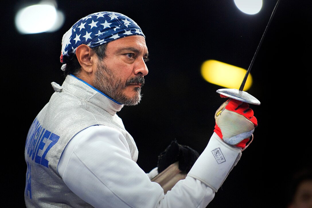 Mario Rodriguez, a former U.S. Air Force staff sergeant and a member of the 2012 U.S. Paralympic fencing team, stands ready before the start of a bout during the Paralympic Games at the ExCeL London exhibition and convention center in London, Sept. 4, 2012.  
