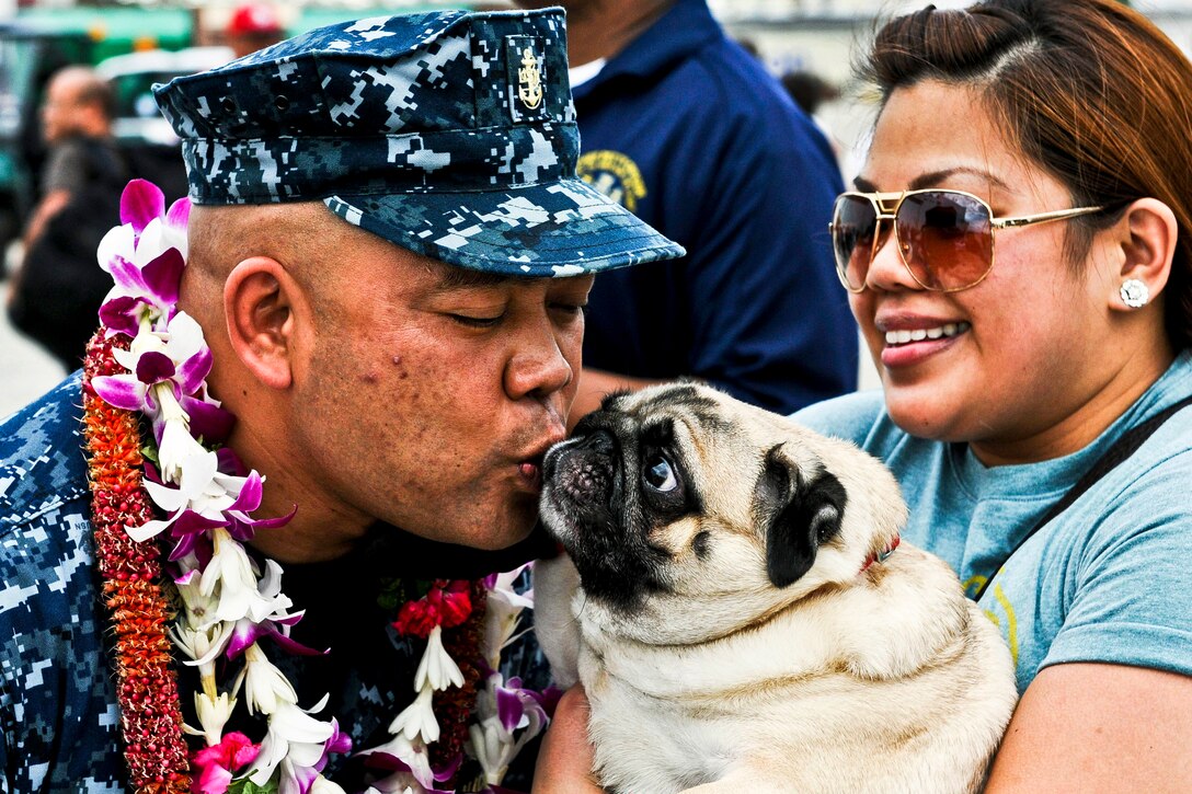 Navy Chief Petty Officer Kevin Sun reunites with his dog and other loved ones after completing Pacific Partnership 2012 as a crewmember of the USNS Mercy in Pearl Harbor, Hawaii, Sept. 2, 2012. The Mercy stopped in Pearl Harbor, Hawaii, to drop off several crewmembers while on its way back to its homeport of San Diego.  
