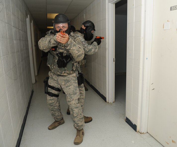 First James Bunyard, 186th Air Refueling Wing, Meridian Miss., secures the hallway during a scenario simulating real world conditions during an active shooter training session hosted by the Federal Bureau of Investigation May 21, 2014, at the Locker House, Keesler Air Force Base, Miss.  The two-day Advanced Law Enforcement Rapid Response Training focused on terrorism response tactics, which is designed to prepare the first responder to isolate, distract, and neutralize an "active shooter."  (U.S. Air Force photo by Kemberly Groue)