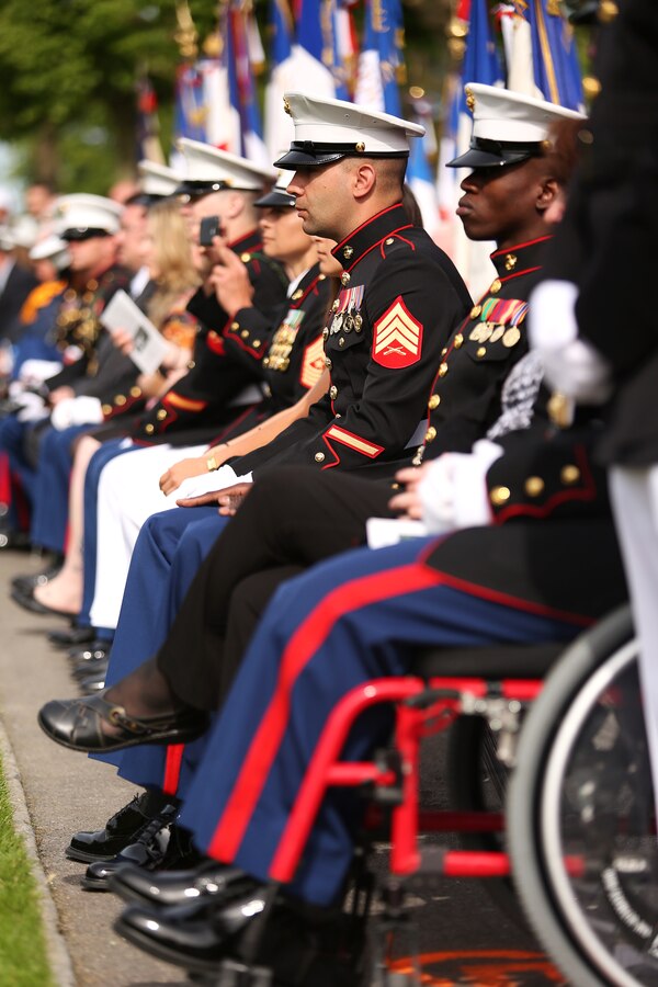 Marines from the Wounded Warrior Regiment observe the Belleau Wood Memorial Day ceremony. United States Marines and their French counterparts gathered at Aisne-Marne American Cemetery May 25 to celebrate Memorial Day, and to mark the 96th anniversary of the historic Battle of Belleau Wood. The event was held in the memorial cemetery which lies adjacent to the historic grounds of Belleau Wood and featured the laying of wreathes, a firing of volleys, the playing of "TAPS," raising of the American and French national colors, and a concert by the French and Marine Corps military bands. The mayor of the village of Bellau along with other military officers and officials representing the U.S. and France were present along with hundreds of locals and visitors from around the world. Participating units from the U.S. Marines included 5th Marine Regiment, the Wounded Warrior Regiment and Marine Forces Europe and Africa. French units that participated in the ceremony included the 21st Marine Infantry Regiment and the Musique Principale des Troupes de Marines.