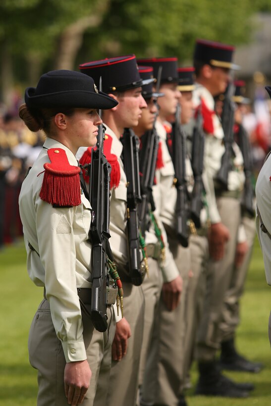 Members of the French 3eme Regiment d' artillerie de Marine stand at attention during the Belleau Wood Ceremony. United States Marines and their French counterparts gathered at Aisne-Marne American Cemetery May 25 to celebrate Memorial Day, and to mark the 96th anniversary of the historic Battle of Belleau Wood. The event was held in the memorial cemetery which lies adjacent to the historic grounds of Belleau Wood and featured the laying of wreathes, a firing of volleys, the playing of "TAPS," raising of the American and French national colors, and a concert by the French and Marine Corps military bands. The mayor of the village of Bellau along with other military officers and officials representing the U.S. and France were present along with hundreds of locals and visitors from around the world. Participating units from the U.S. Marines included 5th Marine Regiment, the Wounded Warrior Regiment and Marine Forces Europe and Africa. French units that participated in the ceremony included the 21st Marine Infantry Regiment and the Musique Principale des Troupes de Marines.

