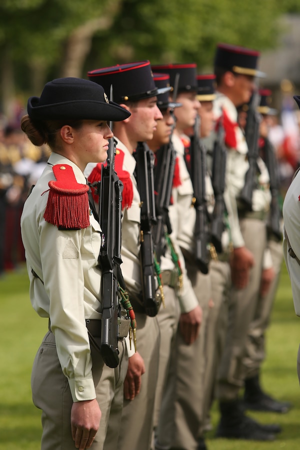 Members of the French 3eme Regiment d' artillerie de Marine stand at attention during the Belleau Wood Ceremony. United States Marines and their French counterparts gathered at Aisne-Marne American Cemetery May 25 to celebrate Memorial Day, and to mark the 96th anniversary of the historic Battle of Belleau Wood. The event was held in the memorial cemetery which lies adjacent to the historic grounds of Belleau Wood and featured the laying of wreathes, a firing of volleys, the playing of "TAPS," raising of the American and French national colors, and a concert by the French and Marine Corps military bands. The mayor of the village of Bellau along with other military officers and officials representing the U.S. and France were present along with hundreds of locals and visitors from around the world. Participating units from the U.S. Marines included 5th Marine Regiment, the Wounded Warrior Regiment and Marine Forces Europe and Africa. French units that participated in the ceremony included the 21st Marine Infantry Regiment and the Musique Principale des Troupes de Marines.

