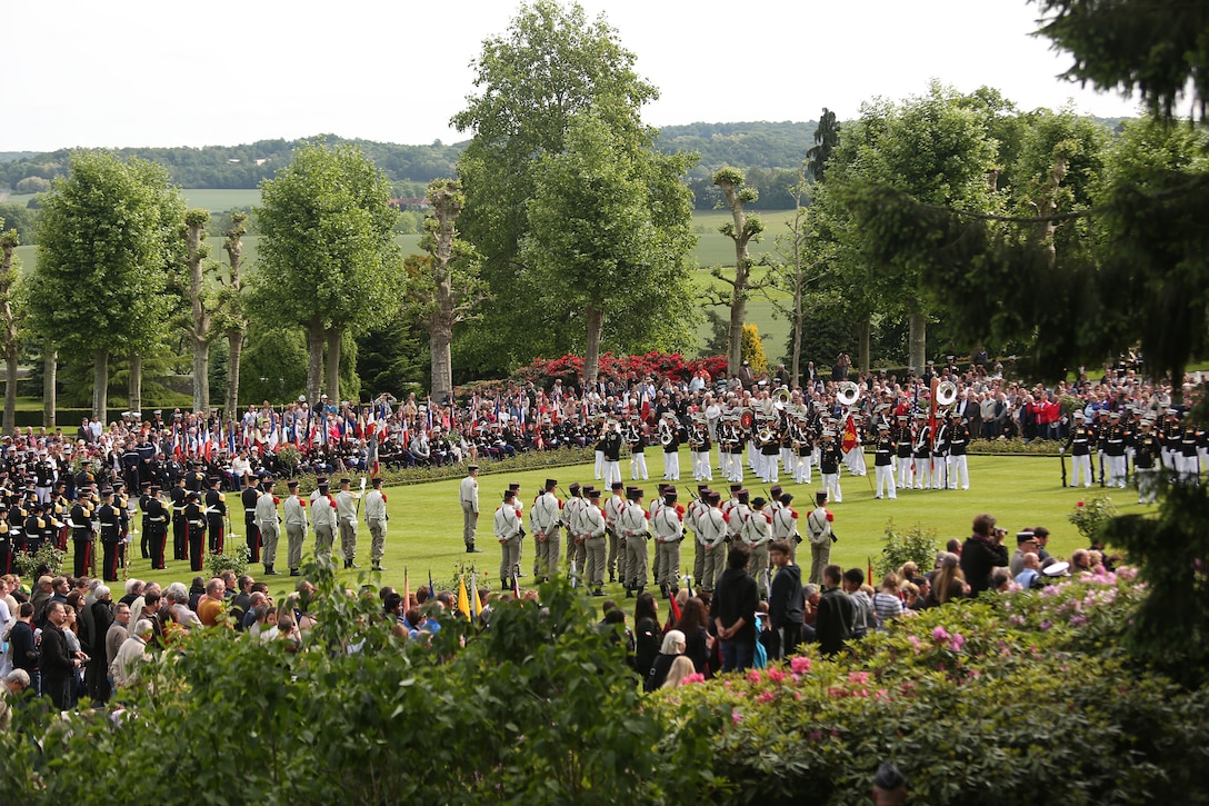 United States Marines and their French counterparts gathered at Aisne-Marne American Cemetery May 25 to celebrate Memorial Day, and to mark the 96th anniversary of the historic Battle of Belleau Wood. The event was held in the memorial cemetery which lies adjacent to the historic grounds of Belleau Wood and featured the laying of wreathes, a firing of volleys, the playing of "TAPS," raising of the American and French national colors, and a concert by the French and Marine Corps military bands. The mayor of the village of Bellau along with other military officers and officials representing the U.S. and France were present along with hundreds of locals and visitors from around the world. Participating units from the U.S. Marines included 5th Marine Regiment, the Wounded Warrior Regiment and Marine Forces Europe and Africa. French units that participated in the ceremony included the 21st Marine Infantry Regiment and the Musique Principale des Troupes de Marines.

