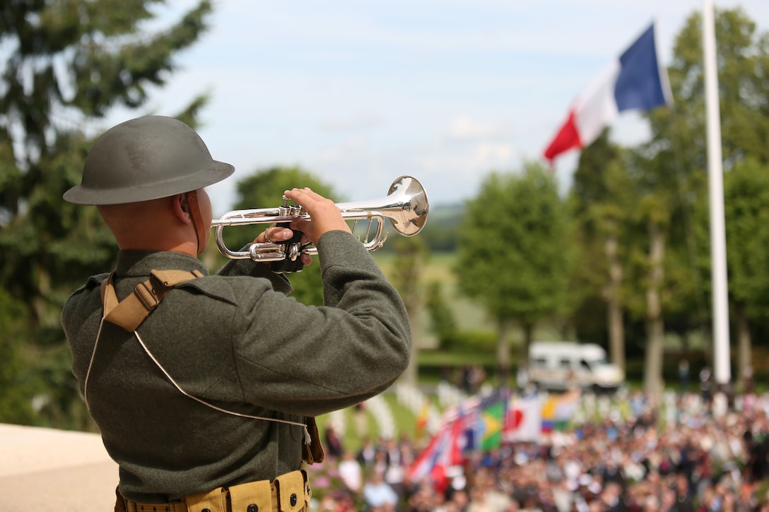 A Marine bugler with the 2d Marine Division Band in period uniform plays "Taps" during the Belleau Wood Ceremony. United States Marines and their French counterparts gathered at Aisne-Marne American Cemetery May 25 to celebrate Memorial Day, and to mark the 96th anniversary of the historic Battle of Belleau Wood. The event was held in the memorial cemetery which lies adjacent to the historic grounds of Belleau Wood and featured the laying of wreathes, a firing of volleys, the playing of "TAPS," raising of the American and French national colors, and a concert by the French and Marine Corps military bands. The mayor of the village of Bellau along with other military officers and officials representing the U.S. and France were present along with hundreds of locals and visitors from around the world. Participating units from the U.S. Marines included 5th Marine Regiment, the Wounded Warrior Regiment and Marine Forces Europe and Africa. French units that participated in the ceremony included the 21st Marine Infantry Regiment and the Musique Principale des Troupes de Marines.



