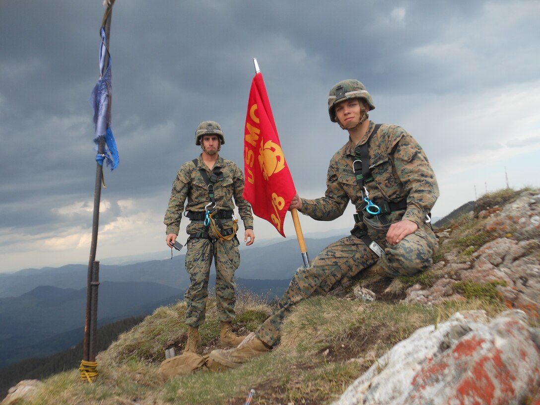 Corporal Scott Bradley and Lance Cpl. Dakota Marshall, two Marines with Black Sea Rotational Force 14 from 3rd Battalion, 8th Marine Regiment, reach the peak of a cliff with two Romanian soldiers of the 17th Mountain Troop Bn. during Exercise Platinum Lynx in the Carpathian Mountains, May 8, 2014. Exercise Platinum Lynx 14-5 is a bilateral exercise between the United States Marines and sailors, and Romanian Land Forces, designed to build familiarity and interoperability between the United States and their Romanian allies through squad and platoon level infantry training. (Courtesy photo)