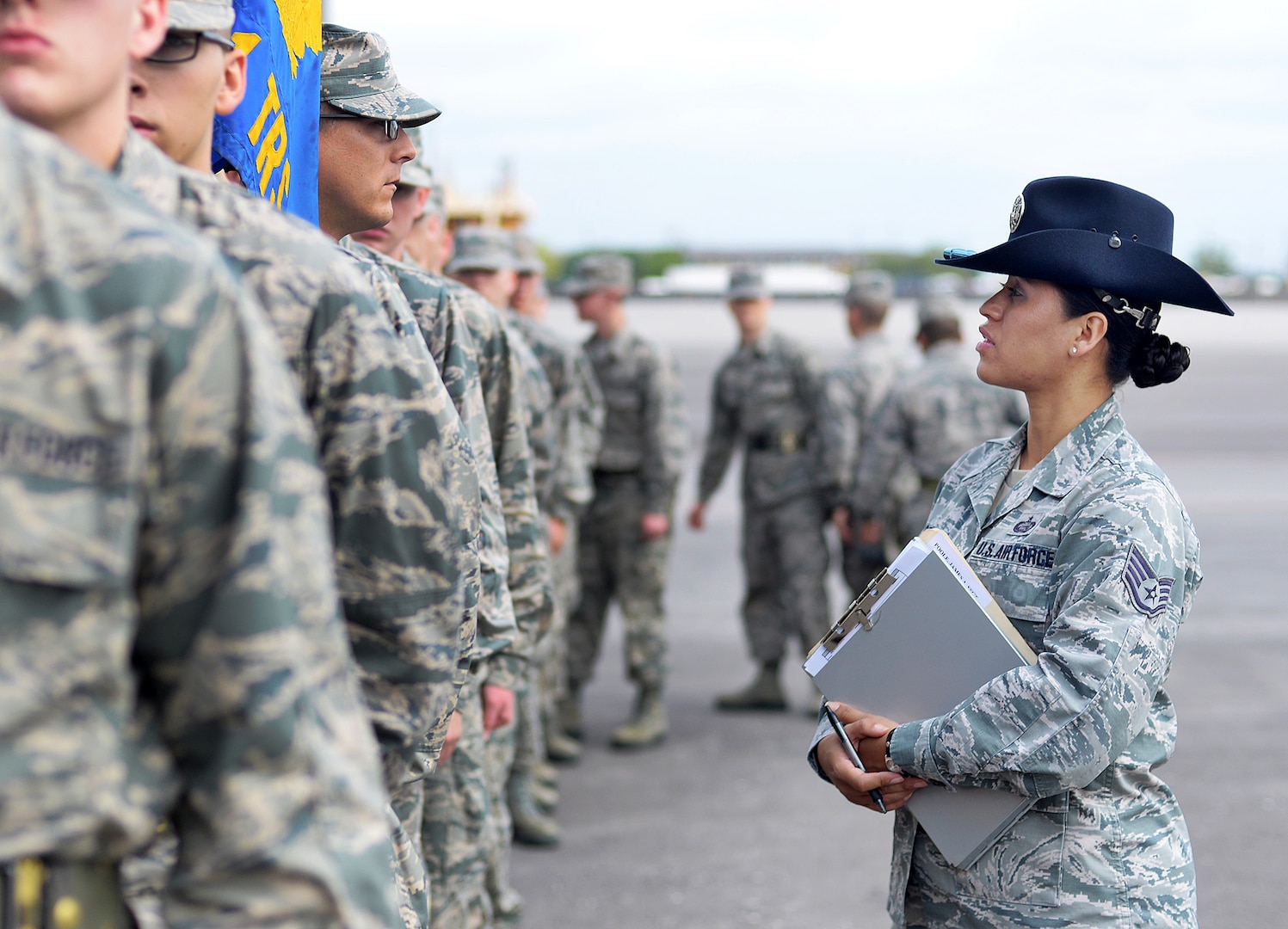 Air Force Staff Sgt. Maria Escobar, a military training instructor with the 737th Training Group, addresses a trainee during basic military training at Joint Base San Antonio-Lackland, Texas, May 20, 2014.  Escobar, a member of the Massachusetts Air National Guard, volunteered for MTI duty to teach and mentor future Airmen.