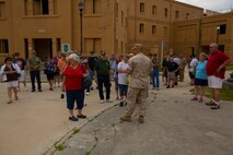 Staff Sgt. Luis Santini Jr. (center), the operations chief for the Military Operations in Urban Terrain section, Headquarters and Support Battalion, Marine Corps Base Camp Lejeune, leads a tour of the MOUT facility for veterans of Mobile Construction Battalion 12 and their family members during a reunion aboard Camp Lejeune, N.C., May 22, 2014. Approximately 50 veterans and family members from MCB-12 visited Camp Lejeune for a day-long tour of the base and to learn about current military engineering equipment and procedures.
