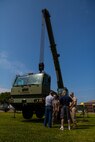 Veterans of Mobile Construction Battalion 12 and Marines with 8th Engineer Support Battalion, 2nd Marine Logistics Group discuss engineering equipment near a Military All-Terrain Crane 50 set up on display during a reunion at Camp Lejeune, N.C., May 22, 2014. The Marines and retired Seabees talked about equipment and procedures used by engineers in the past and present during the day-long tour.