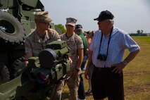 Pfc. Harvey Evans (left), an antitank missileman with 2nd Light Armored Recon Battalion, 2nd Marine Division, discusses a Tube-launched, Optically-tracked, Wire-guided missile launcher with a veteran of Mobile Construction Battalion 12 set up on display during a reunion at Camp Lejeune, N.C., May 22, 2014. Retired sailors who served with MCB-12 during the Vietnam War toured Camp Lejeune and compared equipment and stories during the reunion.