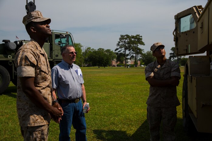 Bob Williams (center left), a veteran who served with Mobile Construction Battalion 12 during the Vietnam War, talks to Marines with 8th Engineer Support Battalion, 2nd Marine Logistics Group about vehicles and equipment set up as a display during a reunion at Camp Lejeune, N.C., May 22, 2014. During MCB-12’s 1968 – 1969 Vietnam deployment, Williams belonged to a team that repaired and reconstructed bridges destroyed by war, a job similar to that performed by Marines with 8th ESB during recent deployments. 