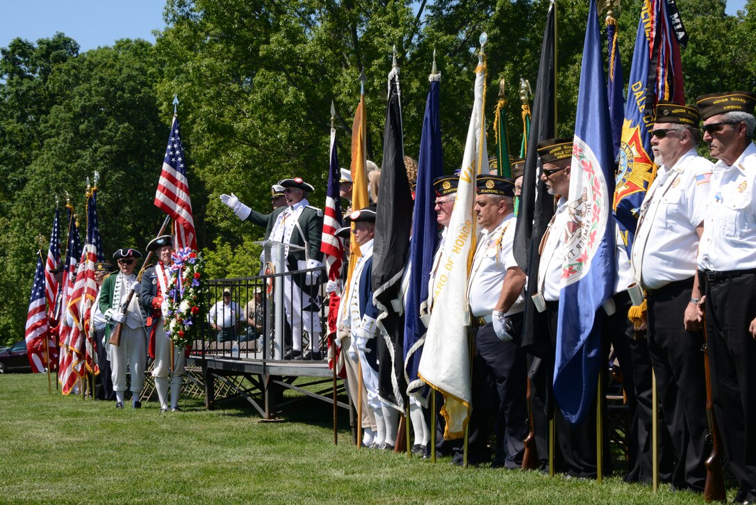 James Newcomer, center, gives a toast to the flag during the Potomac Region Veterans Council Memorial Day Ceremony at the Quantico National Cemetery May 26, 2014. Young and old gathered to memorialize those who have, and will, given their lives for their country. 