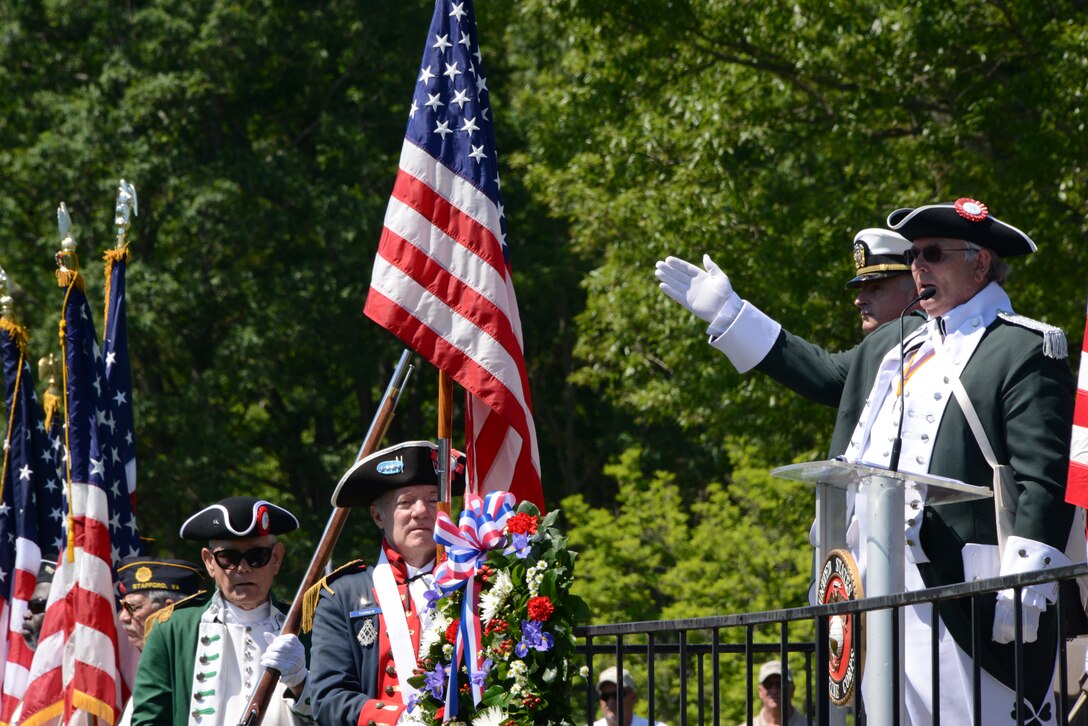 James Newcomer, right, gives a toast to the flag during the Potomac Region Veterans Council Memorial Day Ceremony at the Quantico National Cemetery May 26, 2014. Young and old gathered to memorialize those who have, and will, given their lives for their country. 