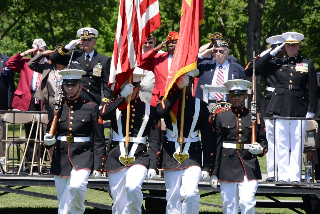 The Marine Corps Base Quantico color guard retires the colors at the conclusion of the Potomac Region Veterans Council Memorial Day Ceremony at the Quantico National Cemetery May 26, 2014. Young and old gathered to memorialize those who have, and will, given their lives for their country. 
