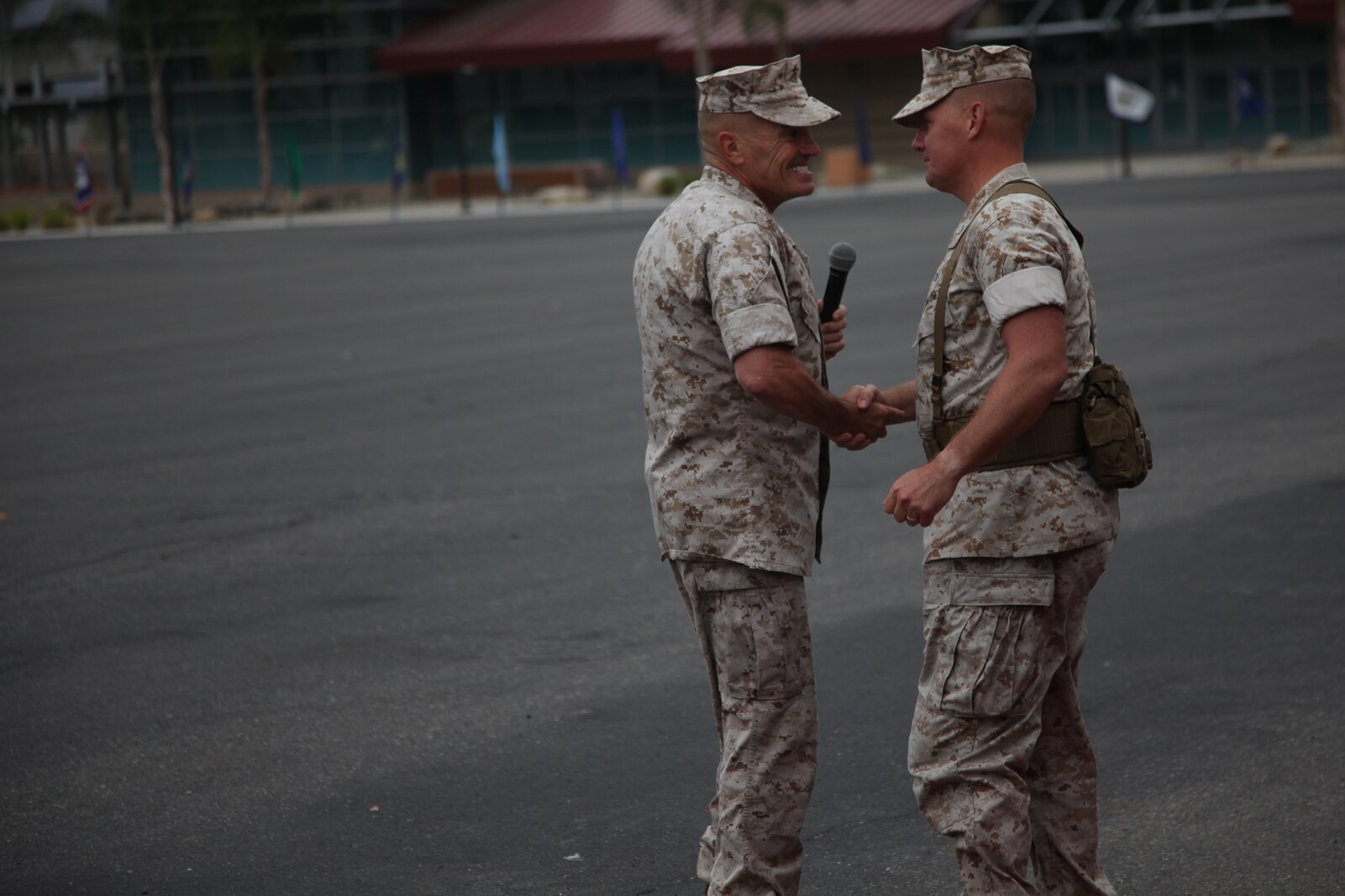 Brigadier Gen. Vincent A. Coglianese, commanding general, 1st Marine Logistics Group, shakes hands with Col. Tracy King, commanding officer, Combat Logistics Regiment 15, 1st MLG, during the unit’s change of command ceremony aboard Camp Pendleton, Calif., May 22, 2014. King passed on the responsibility, authority and accountability of CLR-15 to Col. Seth Ocloo, who recently served as the assistant chief of staff for logistics at the 3rd Marine Aircraft Wing.