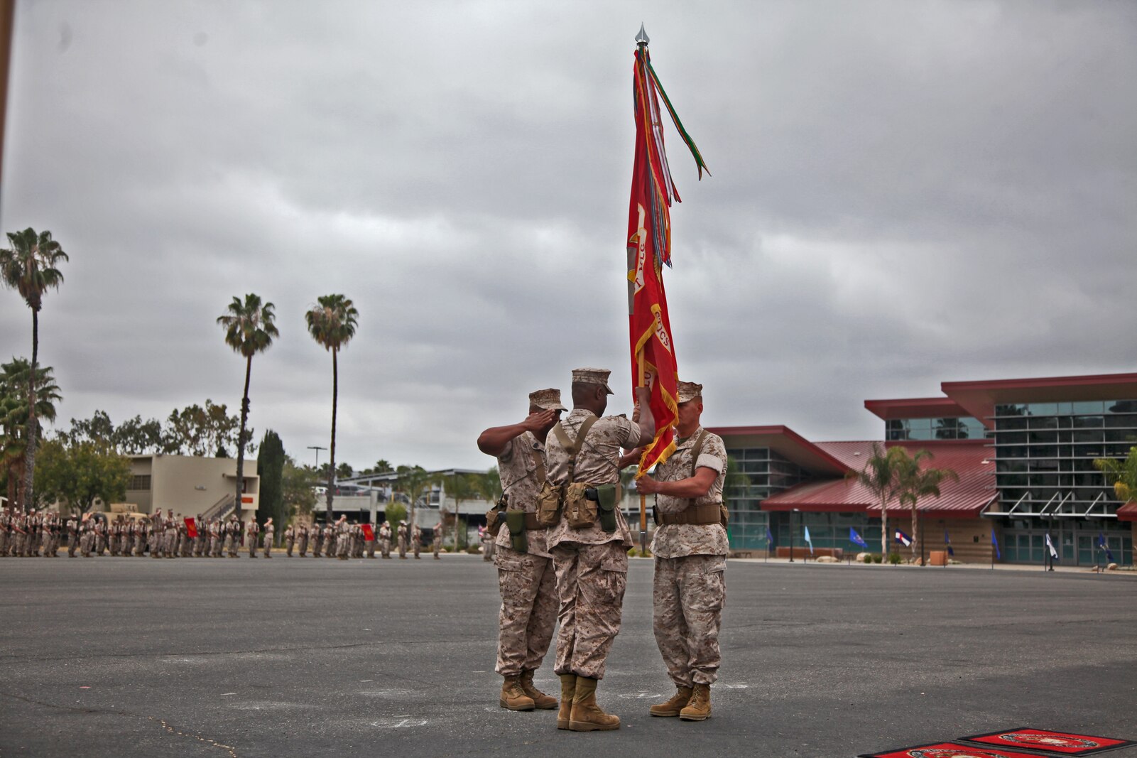 Colonel Tracy King, commanding officer, Combat Logistics Regiment 15, 1st Marine Logistics Group, passes his regiment’s battle colors to Col. Seth Ocloo during a change of command ceremony aboard Camp Pendleton, Calif., May 22, 2014. Ocloo, who recently served as the assistant chief of staff for logistics at the 3rd Marine Aircraft Wing, received his new duty with enthusiasm. 