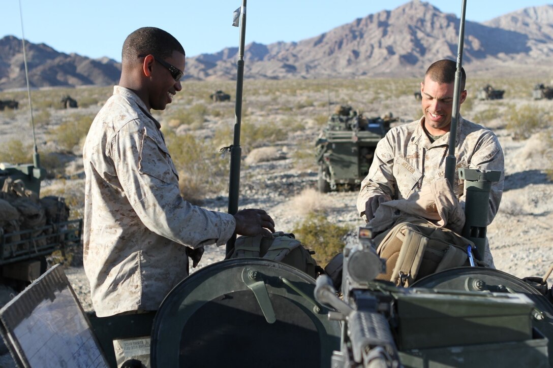 Capt. Chester Carter, left, commanding officer of Delta Company, 1st Light Armored Reconnaissance Battalion, and Sgt. Garrett Mellor, a gunner with the company, discuss operations and fire plans during Exercise Desert Scimitar aboard Marine Corps Air Ground Combat Center Twentynine Palms, Calif., May 14, 2014. Desert Scimitar is a large-scale exercise involving air, ground and logistical elements from I Marine Expeditionary Force.