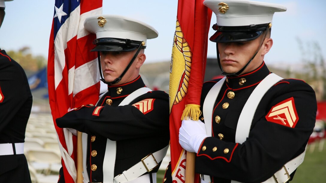 Sgt. Jamean Berry, left, combat photographer, 15th Marine Expeditionary Unit, practices color guard movements before presenting the colors during a commencement ceremony at Palomar College campus in San Marcos, Calif., May 20, 2014. Berry is from Colorado Springs, Colo. (U.S. Marine Corps photo by Lance Cpl. Anna Albrecht/Released)
