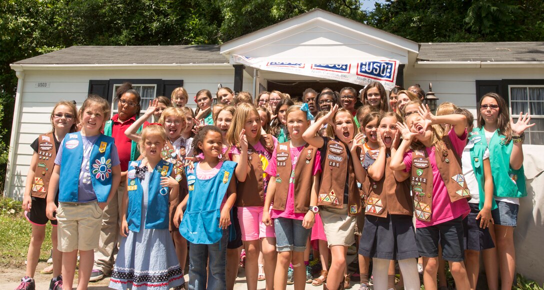 Girl Scouts pose with silly faces after donating more 3,000 boxes of cookies to the USO of North Carolina in Jacksonville during Operation Cookie Drop, May 22. The USO will use the cookies for homecomings, deployments, and other events for service members and their families.