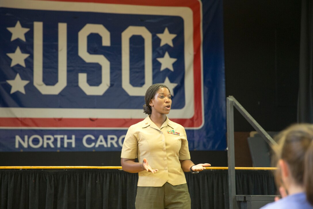 Warrant Officer Crystal Ledbetter, the officer in charge of administrative support with Headquarters and Support Battalion’s Legal Services Support Section, speaks to Girl Scouts at the USO of North Carolina in Jacksonville during Operation Cookie Drop, May 22. The Girl Scouts donated more 3,000 boxes of cookies to the USO. The USO will use the cookies for homecomings, deployments and other events for service members and their families