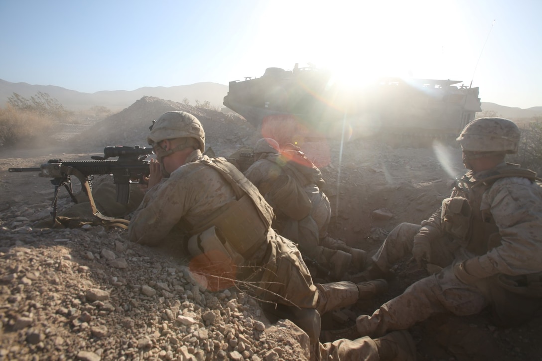 Marines with 2nd Battalion, 4th Marine Regiment, fire from a fighting-hole while maintaining a battalion-level defense during Exercise Desert Scimitar aboard Marine Corps Air Ground Combat Center Twentynine Palms, Calif., May 12, 2014. Desert Scimitar is an annual combined-arms exercise to ensure I Marine Expeditionary Force is prepared to face any crisis worldwide.