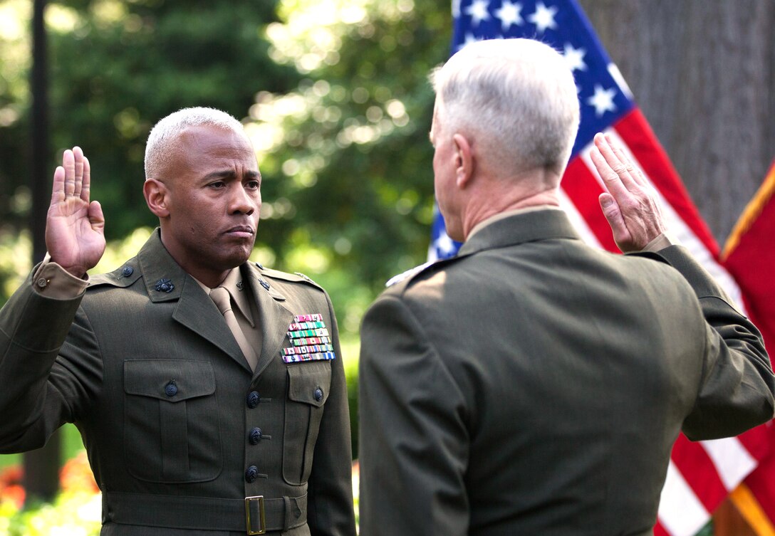 Brig. Gen. Terry Williams (sel.), director of communication for the Marine Corps, renews his oath of enlistment during his promotion ceremony in the garden of the Home of the Commandants, May 27, 2014. Williams was the last of the brigadier general selects to be promoted for fiscal year 2014. 