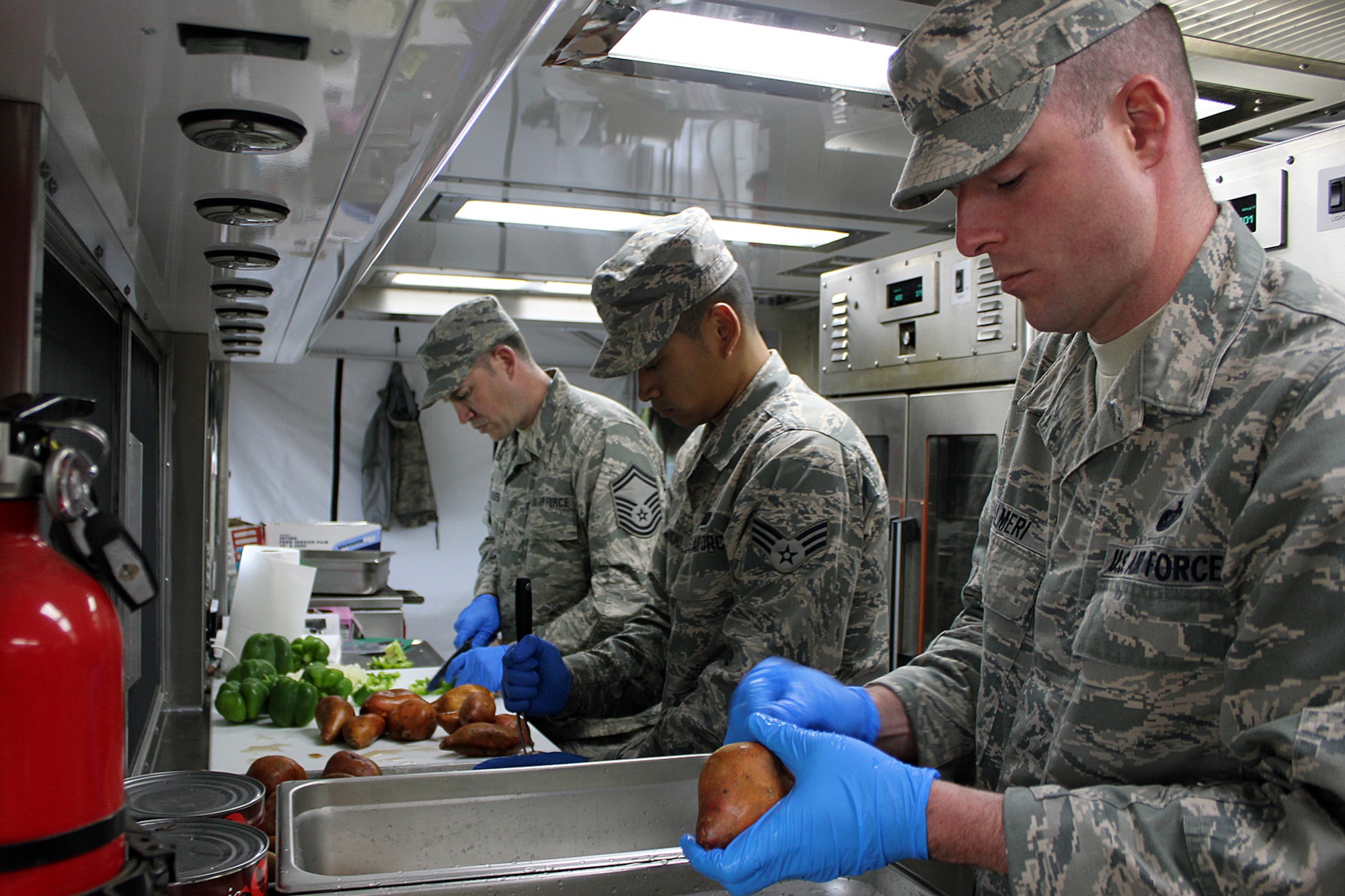 140528-Z-VA676-016  Senior Master Sgt. James Alves, Senior Airman Anthony Hammond and Technical Sgt. Ken Palmeri prepare dinner utilizing a Disaster Relief Mobile Kitchen Trailer at Camp Hinds Boy Scout camp, Raymond, Maine, May 28, 2014. The Airmen are part of an Innovative Readiness Training mission at the camp, which allows military personnel to get training in various tasks and a community organization, in this case the Boy Scouts, to benefit from the work. Air National Guard, Marine and Army Reserve units from about a dozen different states will be working on a construction project at the camp during summer 2014. Alves and Palmeri are Services specialists with the 127th Force Support Squadron, Michigan Air National Guard. Hammond is with the 143rd FSS, Rhode Island ANG. (U.S. Air National Guard photo by Technical Sgt. Dan Heaton)